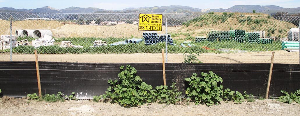 Creston temporary fencing with debris netting at a construction site.